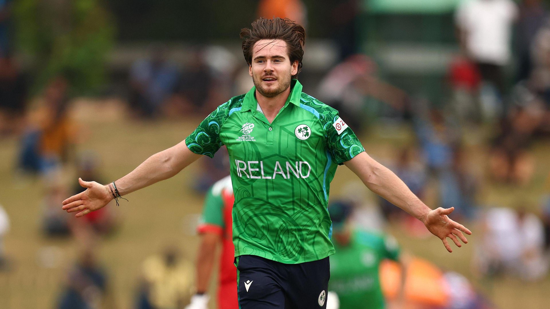 Josh Little spreads his arms in celebration