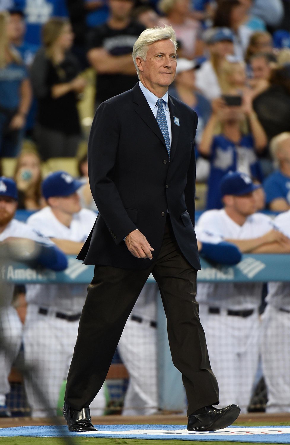 Dodgers owner Mark Walter walks onto the field at Dodger Stadium during a pre-game ceremony.