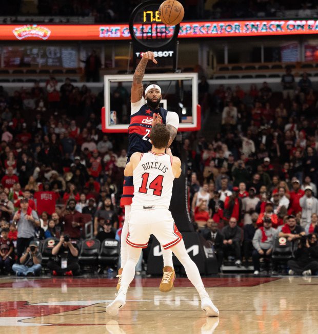 Bulls forward Matas Buzelis (14) intentionally fouls Wizards forward Anthony Davis late in the fourth quarter Saturday, Oct. 24, 2026, at the United Center. (Arthur Maiorella/Chicago Tribune)