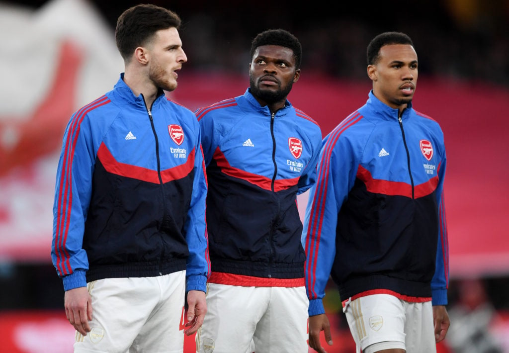 Declan Rice, Thomas Partey and Gabriel of Arsenal look on ahead of kick-off prior to the Premier League match between Arsenal FC and Chelsea FC at ...