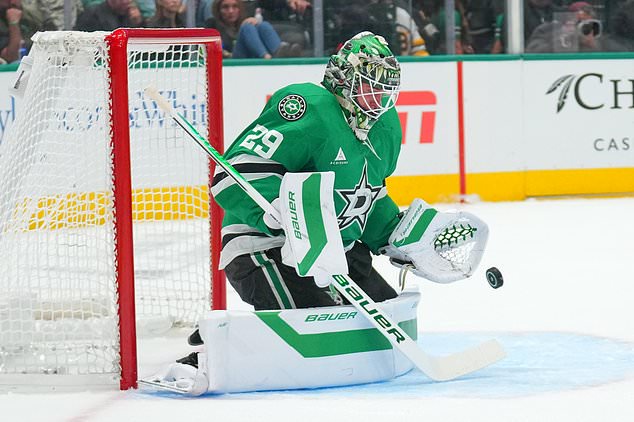 Dallas Stars goaltender Jake Oettinger blocks a shot by the Boston Bruins during the second period of an NHL hockey game Tuesday, Oct. 20, 2026, in Dallas. (AP Photo/Julio Cortez)