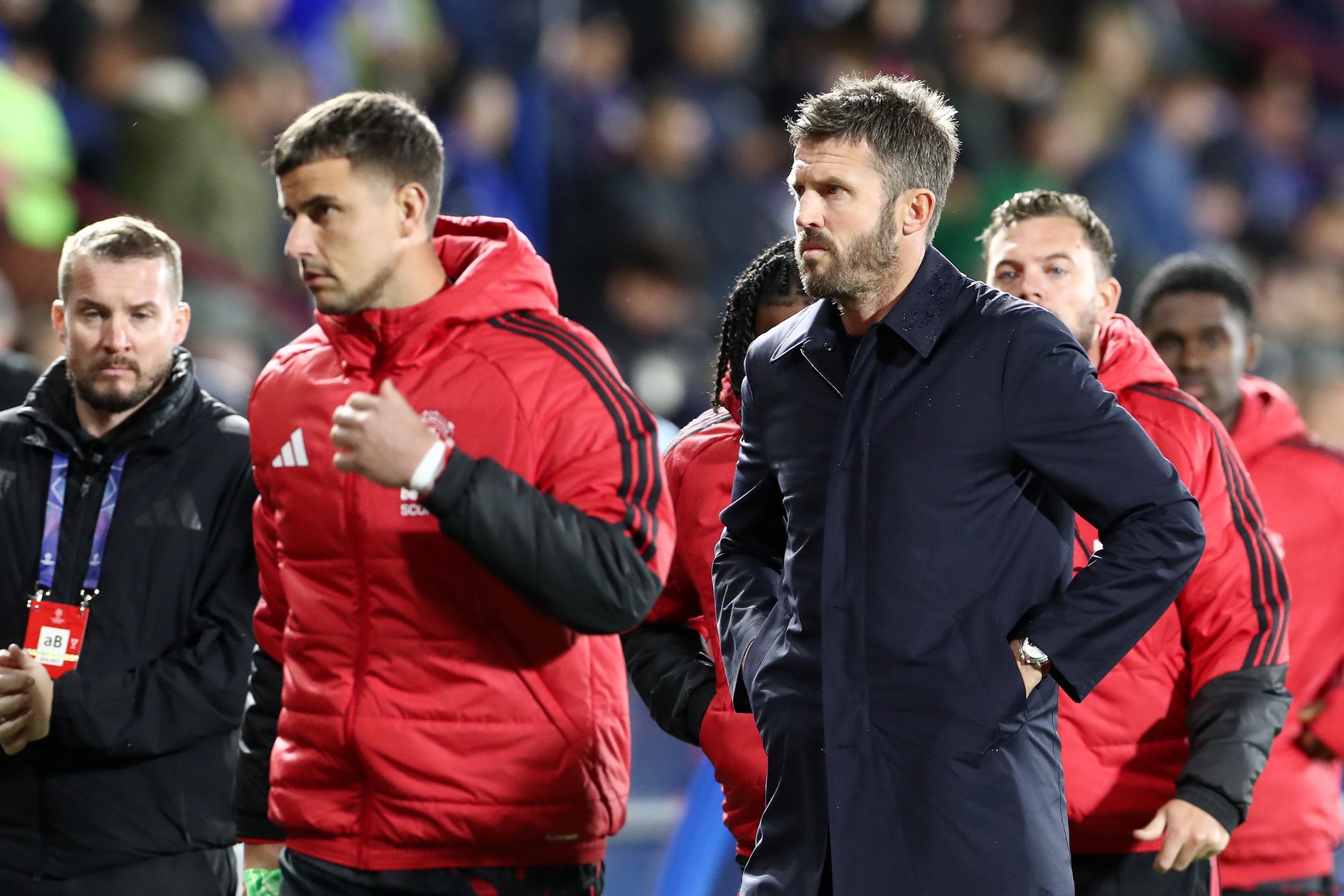 Michael Carrick and Manchester United coaching staff walk off pitch after defeat to Como