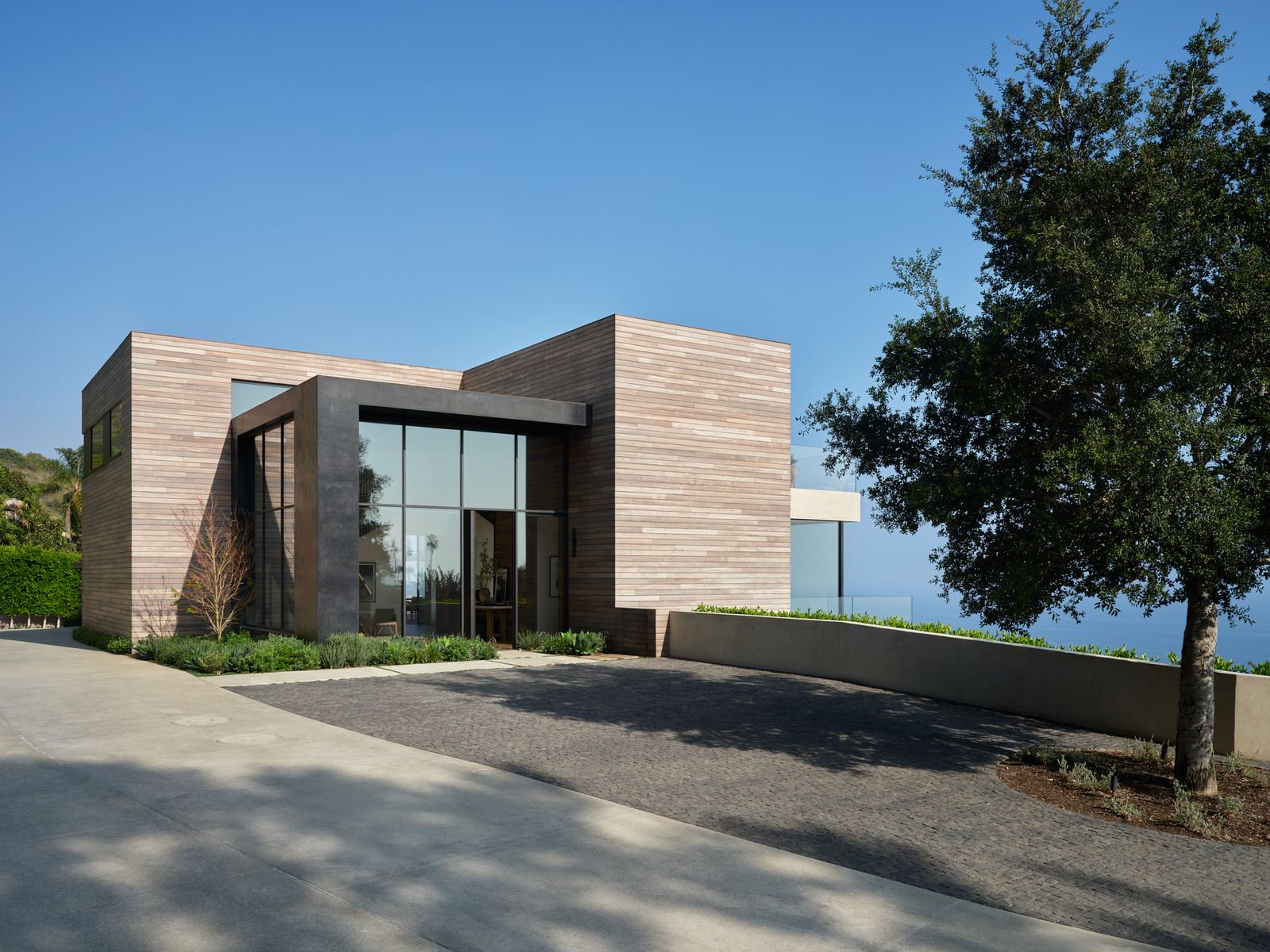 boxy modern home exterior driveway tree