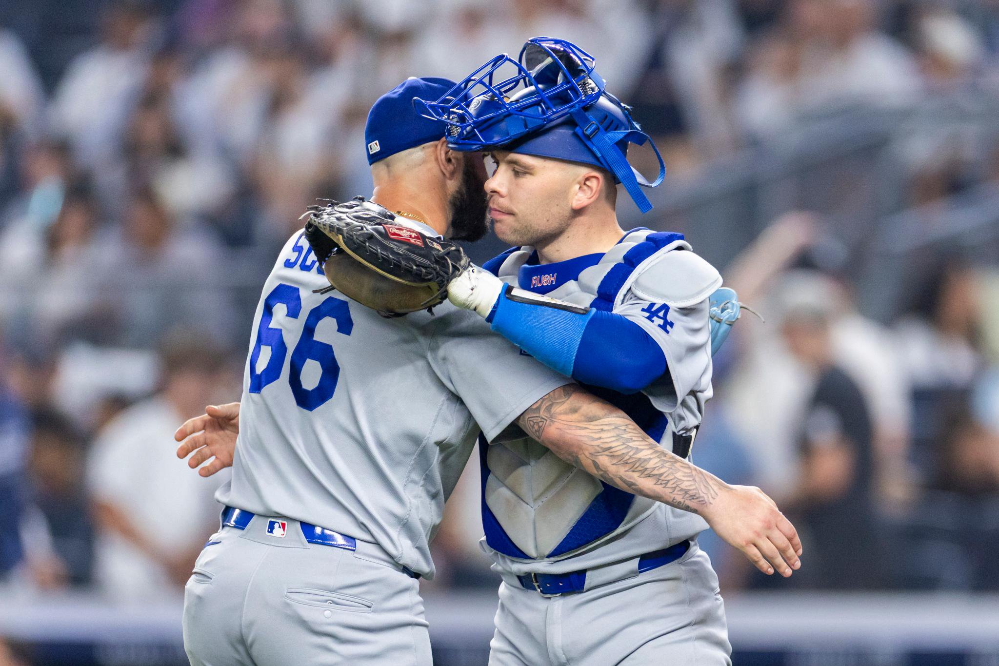 Los Angeles Dodgers pitcher Tanner Scott hugs catcher Dalton Rushing after a game.