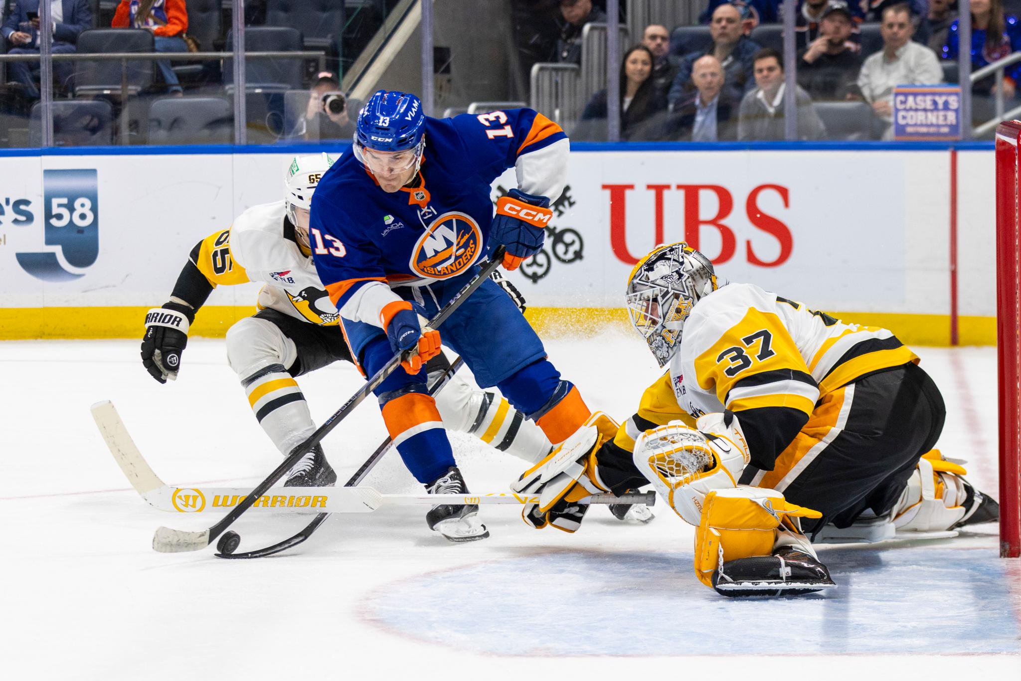 Pittsburgh Penguins goaltender Arturs Silovs (37) defends the net against New York Islanders center Mathew Barzal (13) during the first period at UBS Arena in Elmont, N.Y., Monday, March 30, 2026.