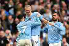 Erling Haaland of Manchester City celebrates scoring his team's fourth goal with teammates Phil Foden and Bernardo Silva during the Premier League match between Manchester City and Wolverhampton Wanderers