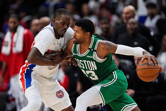 Detroit Pistons guard Javonte Green (31) defends Boston Celtics forward Paul George (13) in the second half of an NBA basketball game in Detroit, Tuesday, Oct. 20, 2026. (AP Photo/Paul Sancya)