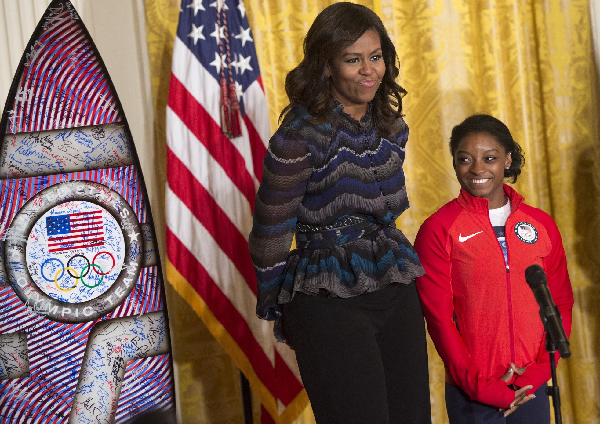 US First Lady Michelle Obama and US Olympic gymnast Simone Biles during a ceremony honoring the 2016 US Olympic and Paralympic teams during an event in the East Room of the White House in Washington, DC, September 29, 2016. 