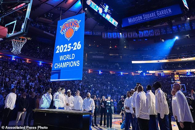 New York Knicks players look on as the 2025-26 World Champions banner is raised before an NBA basketball game between the Knicks and the Philadelphia 76ers Tuesday, Oct. 20, 2026, in New York. (AP Photo/Frank Franklin II)