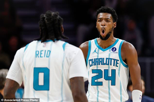 Charlotte Hornets forward Brandon Miller (24) reacts after center Naz Reid (0) made a 3-point basket during the second half of an NBA basketball game against the Washington Wizards in Charlotte, N.C., Monday, Oct. 26, 2026. (AP Photo/Nell Redmond)
