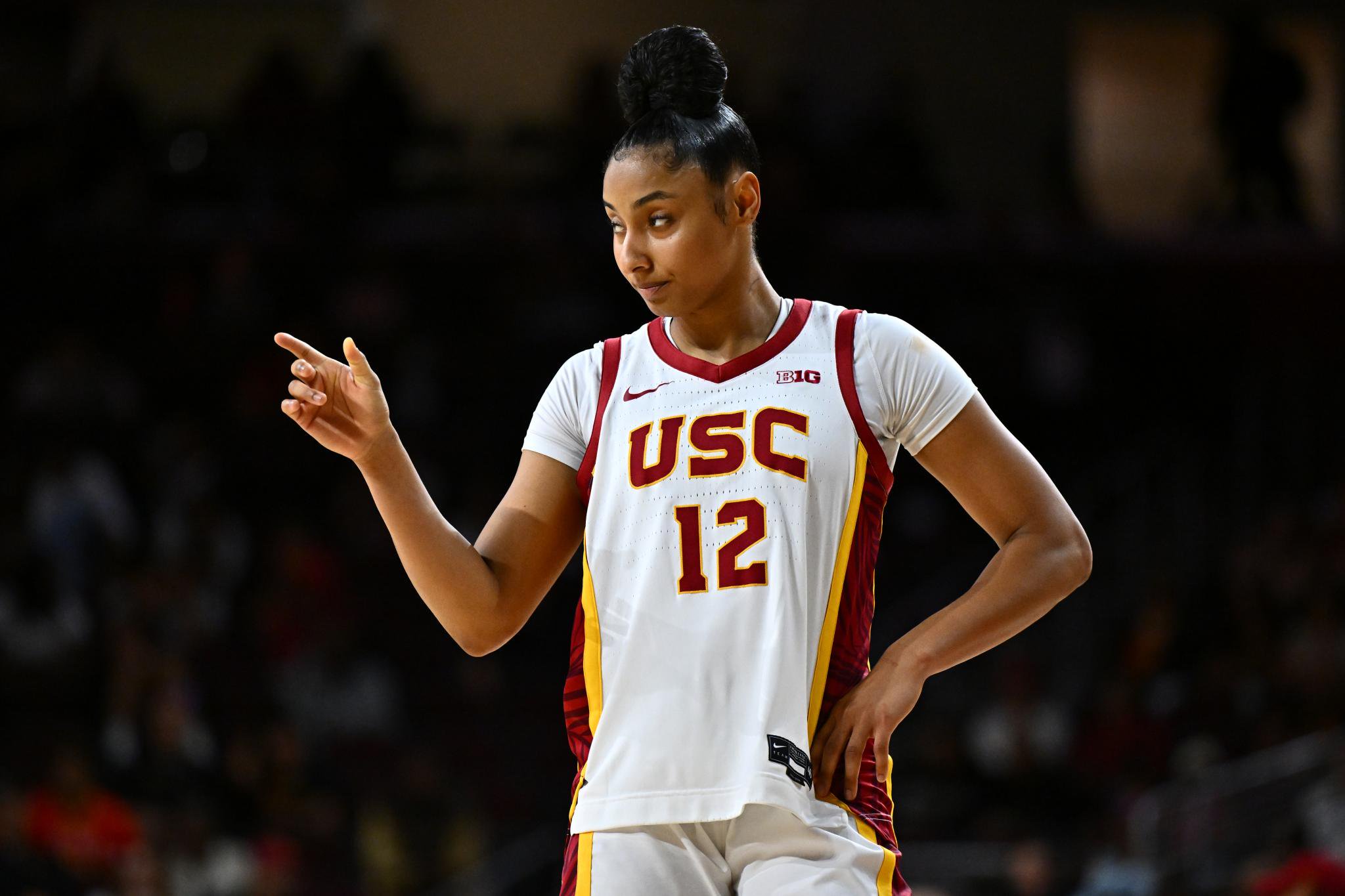 Juju Watkins wearing a USC basketball uniform and pointing.