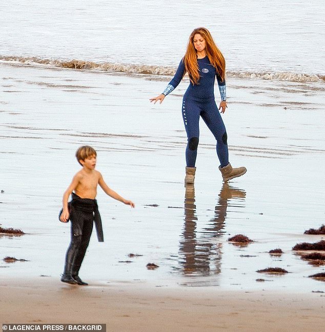 Surfing: She flaunted her natural good looks as she appeared to go make-up free for her sporty day out catching some waves