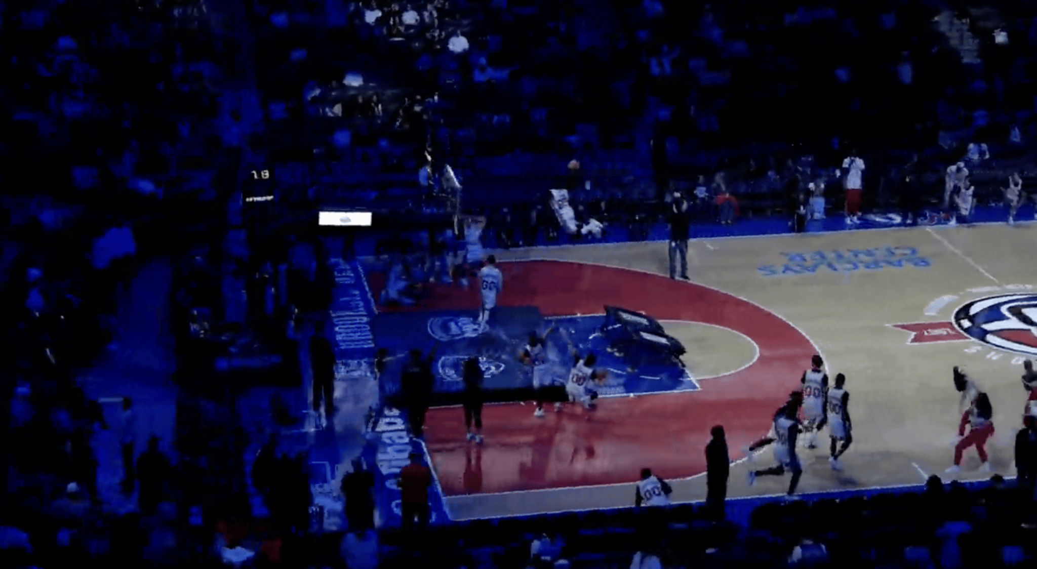 A basketball game in a large arena, viewed from high above.