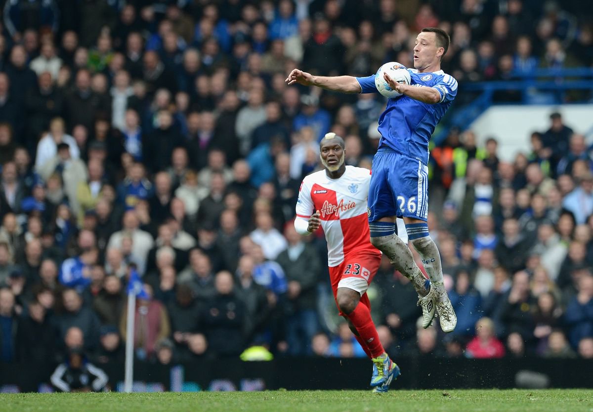  John Terry of Chelsea controls the ball watched by Djibril Cisse of Queens Park Rangers during the Barclays Premier League match between Chelsea and Queens Park Rangers at Stamford Bridge on April 29, 2012 in London, England