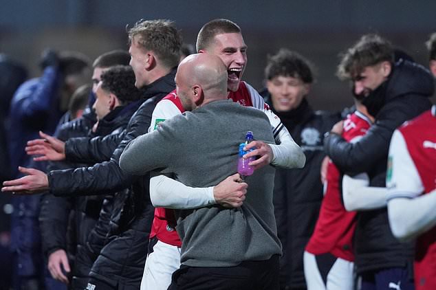 Fleetwood's coach Matt Lawlor celebrates with his players after winning a penalty shootout during the English League Cup soccer match between Fleetwood Town and Arsenal in Fleetwood, England, Tuesday, Oct. 27, 2026. (AP Photo/Ian Hodgson)
