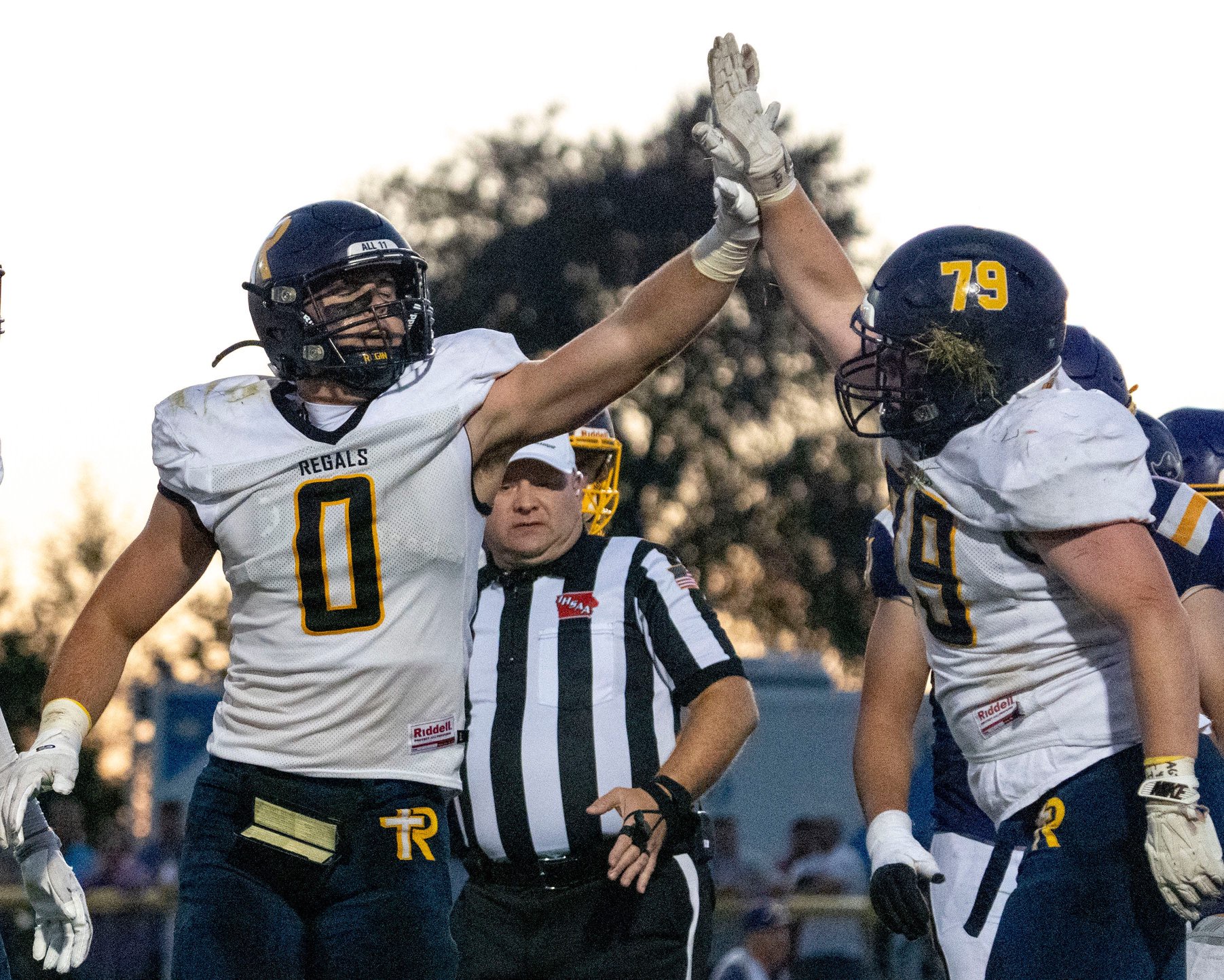 ReginaÕs Tate Wallace (0) high fives Porter Shetler (79) during a high school football game against the Alburnett Pirates Sept. 10, 2026 in Alburnett, Iowa.