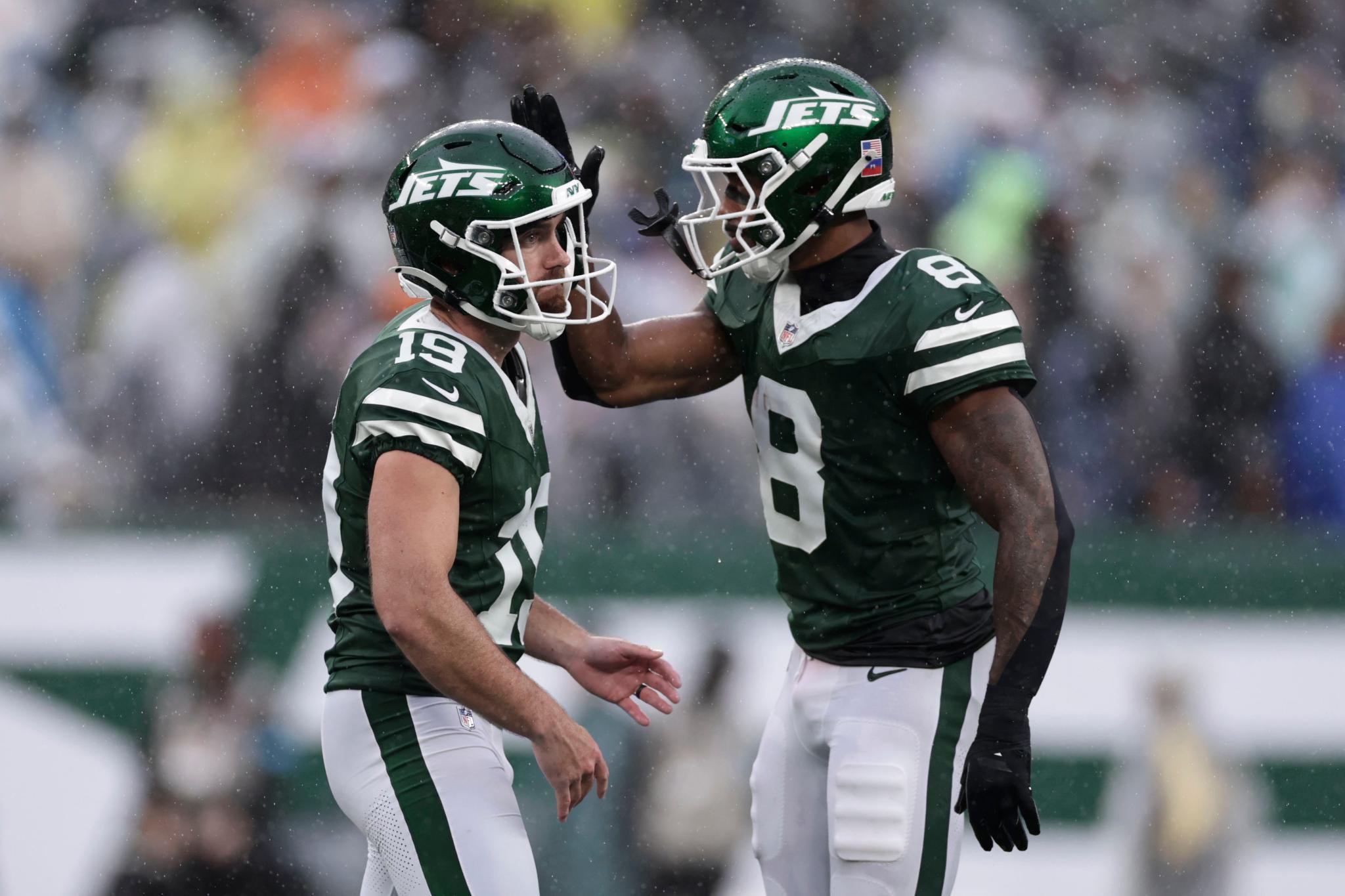 New York Jets place kicker Jason Sanders (19) celebrates with teammate Andre Cisco (8) after kicking a field goal during an NFL football game against the Cleveland Browns.
