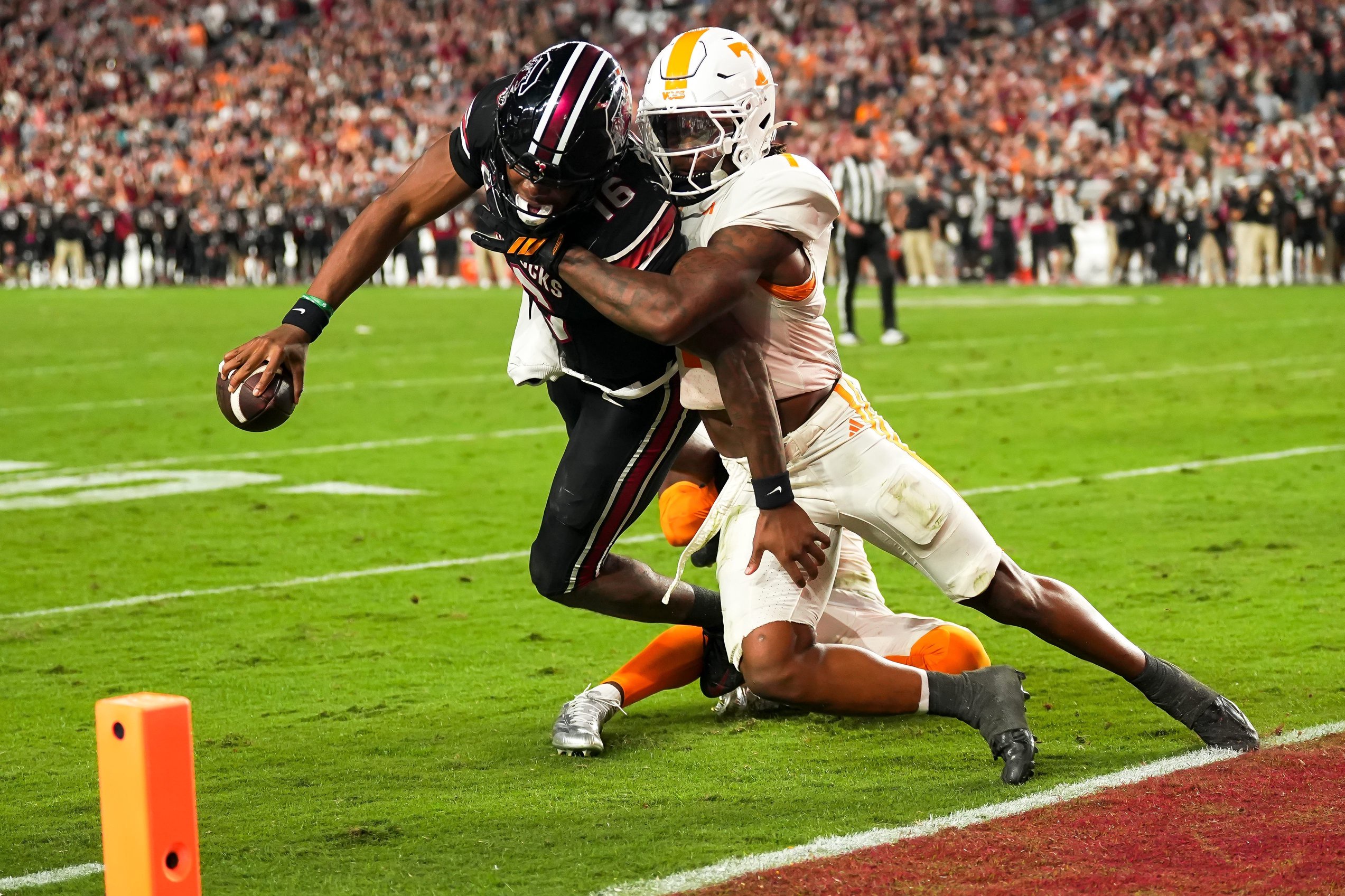 South Carolina quarterback LaNorris Sellers (16) fights a tackle attempt by Tennessee defensive back TJ Metcalf (1) to reach the end zone for a touchdown during the fourth quarter at Williams-Brice Stadium.