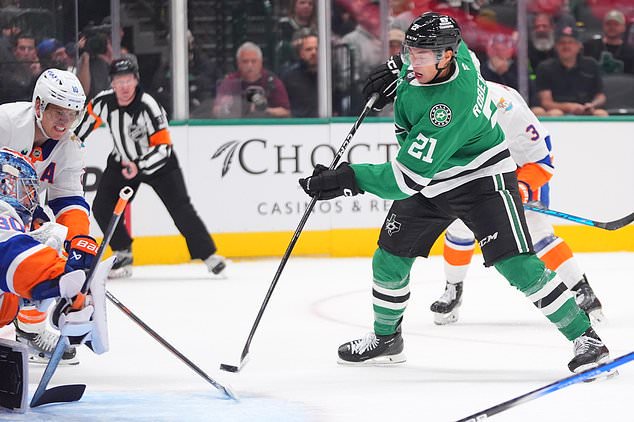 Dallas Stars left wing Jason Robertson (21) scores against New York Islanders goaltender Ilya Sorokin (30) and center Brayden Schenn (10) during the first period of an NHL hockey game Sunday, Oct. 25, 2026, in Dallas. (AP Photo/LM Otero)