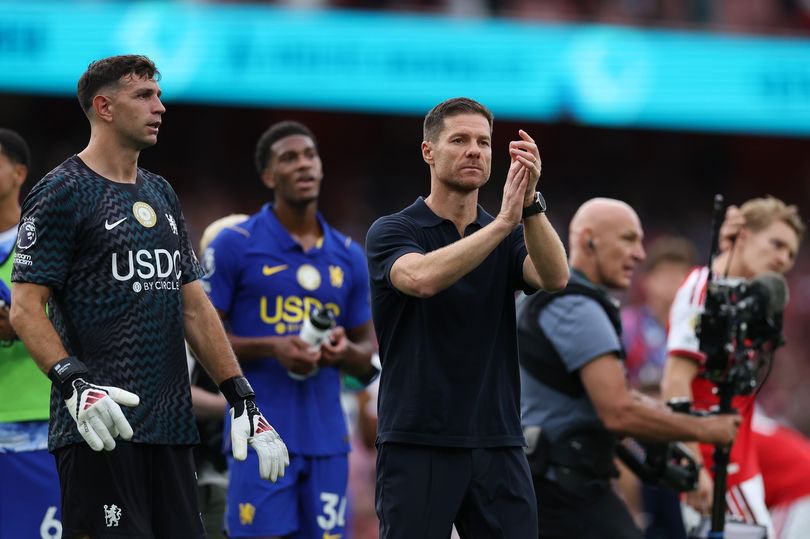 Xabi Alonso applauds the Chelsea supporters following the defeat at Arsenal