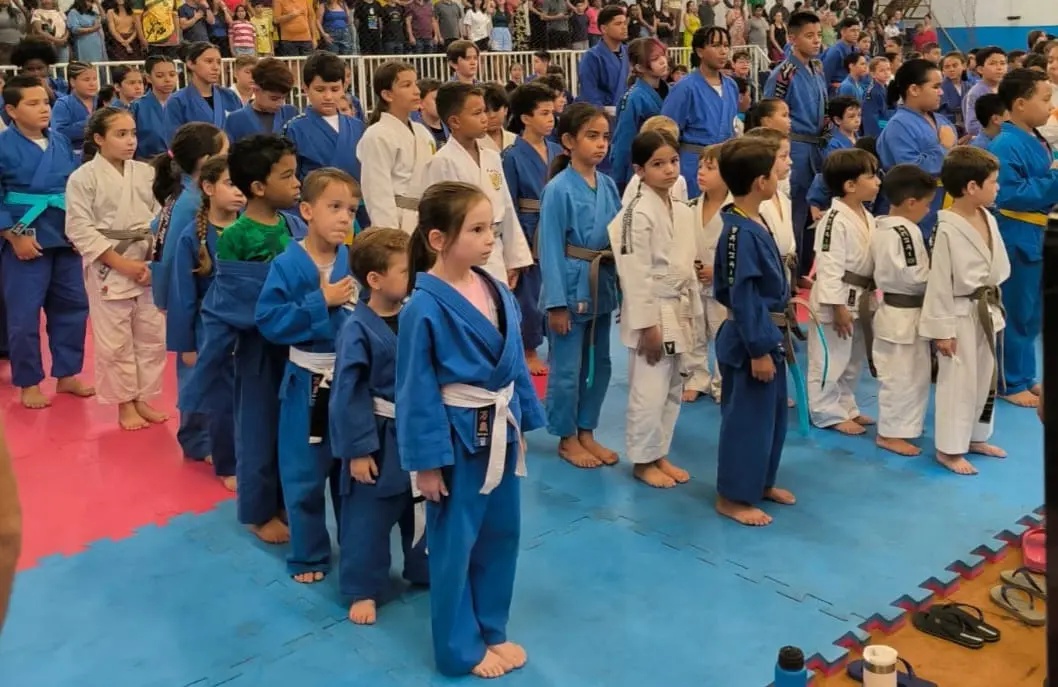 A imagem mostra alguns atletas de Judô em fila.