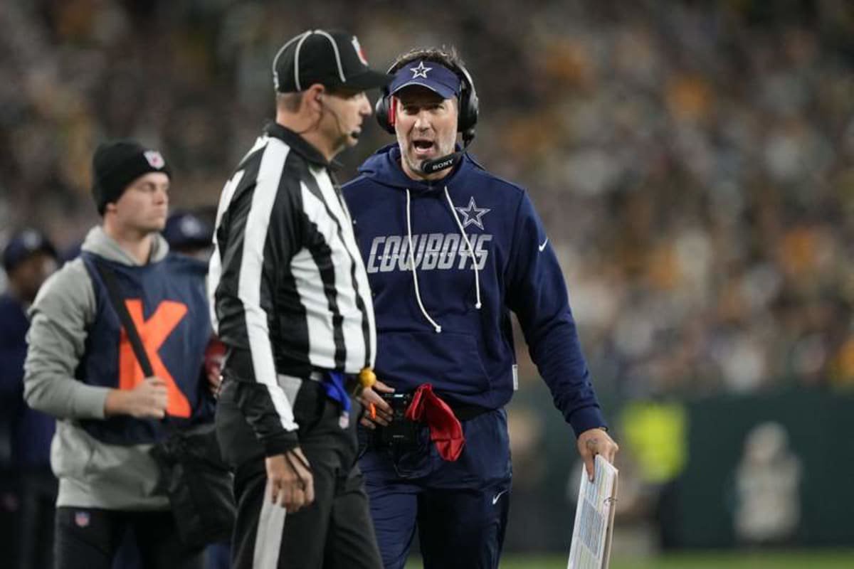 Dallas Cowboys head coach Brian Schottenheimer talks with an official during the first half of the game against the Green Bay Packers at Lambeau Field. (Jeff Hanisch-Imagn Images)