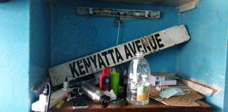 Kenyatta Avenue signpost on a table with other household items