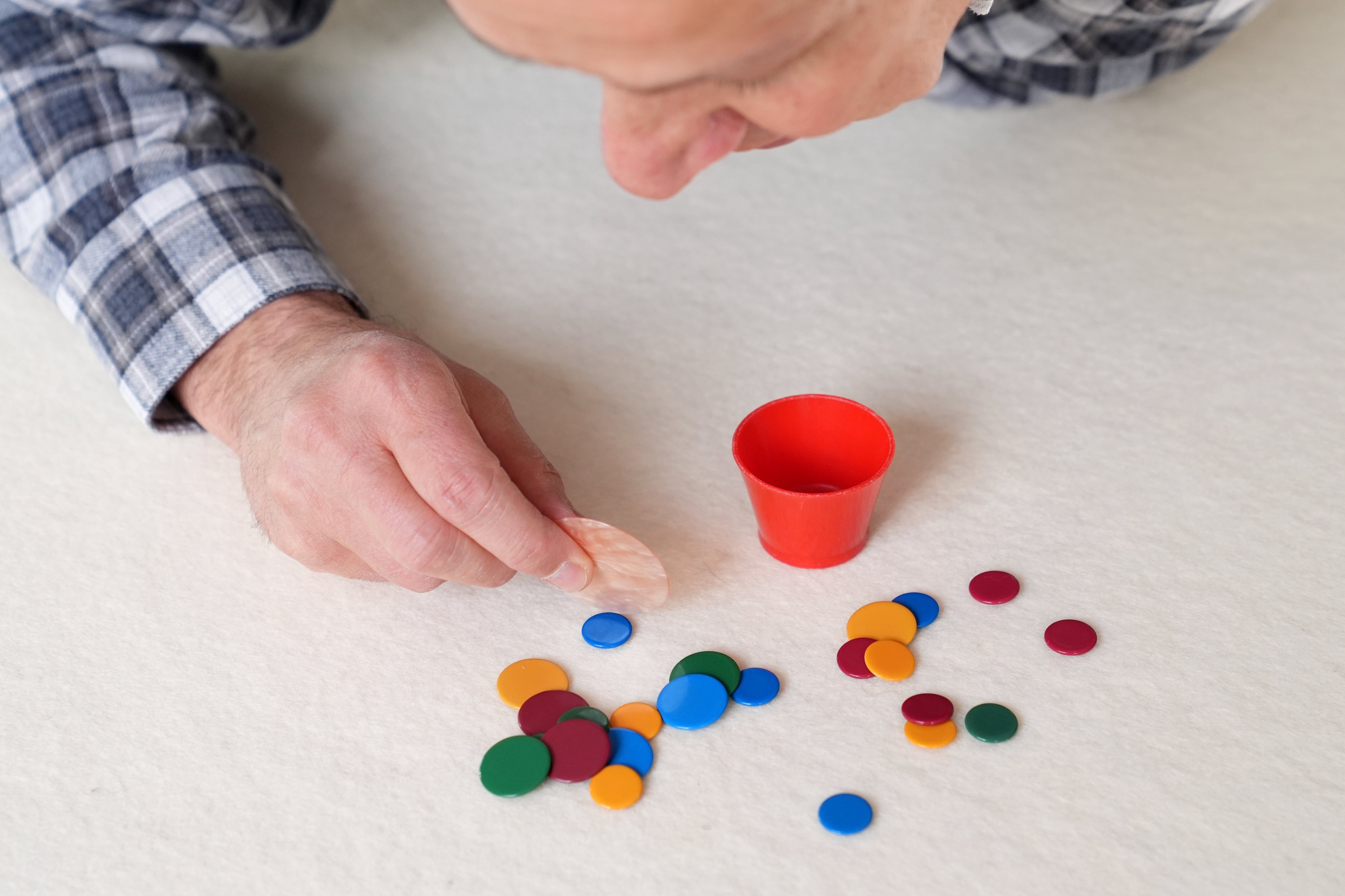 Tiddlywinks is a game in which players try to get small plastic discs into a cup by pressing one piece against another to make it fly through the air (Joe Giddens/PA)