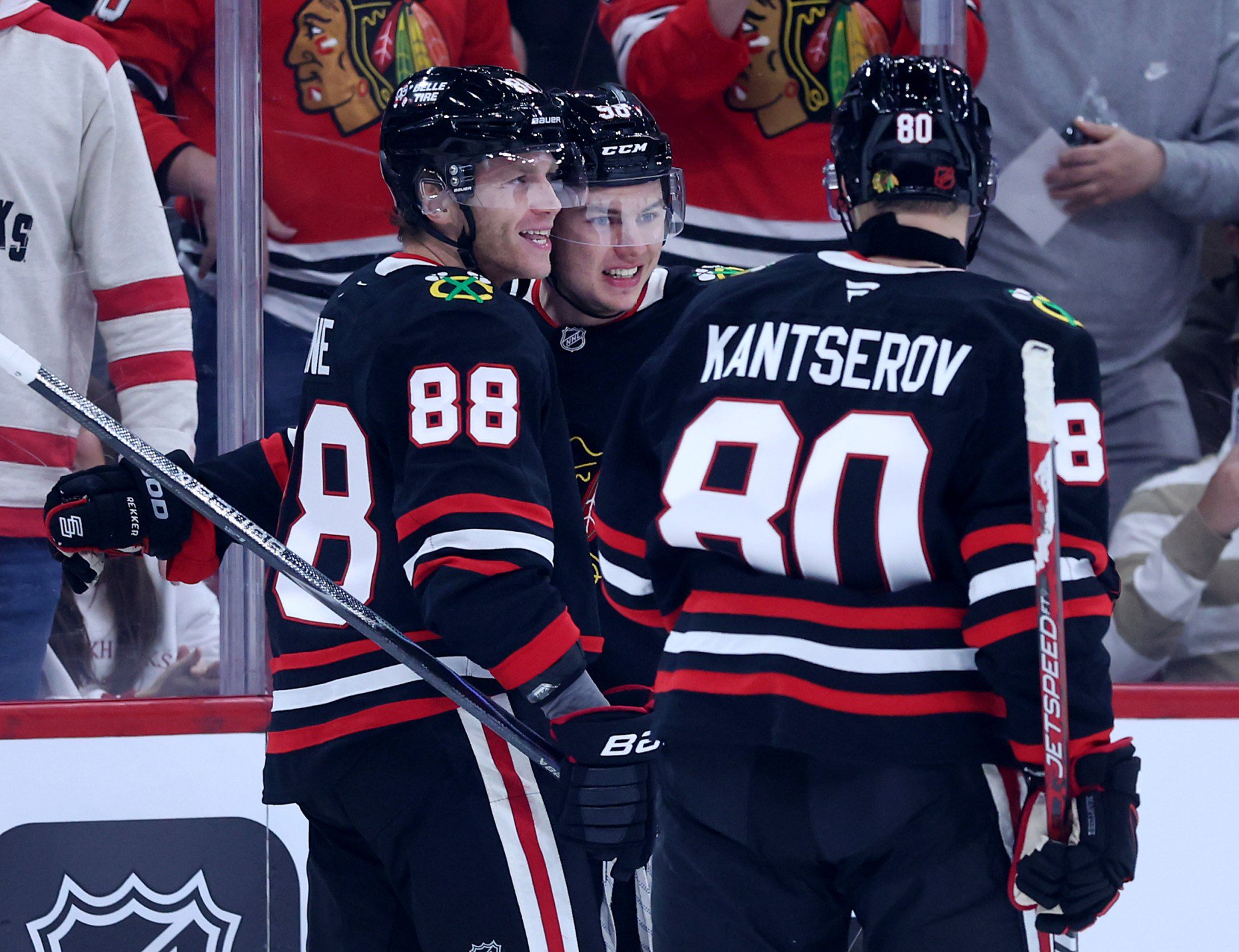 Chicago Blackhawks center Connor Bedard (98) celebrates with teammates Patrick Kane (88) and Roman Kantserov (80) after Bedard scored a goal in the first period of a game against the Montréal Canadiens at the United Center in Chicago on Oct. 23, 2026. (Chris Sweda/Chicago Tribune)