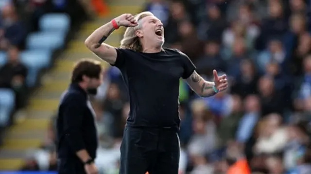 Peterborough manager Robbie Savage punches the air in celebration on the touchline at the King Power