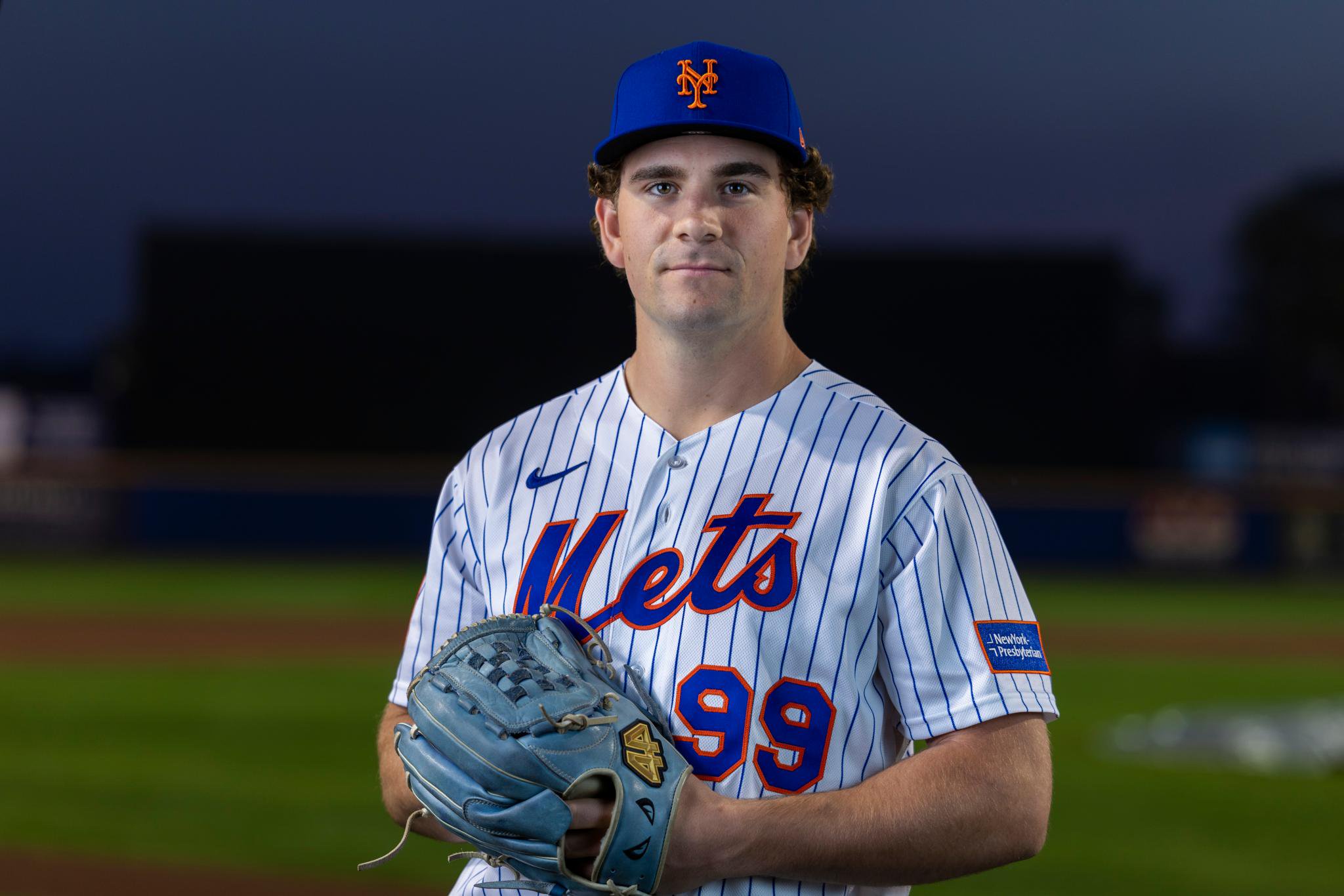 New York Mets pitcher Ryan Lambert poses in a pinstripe jersey and blue cap at spring training.