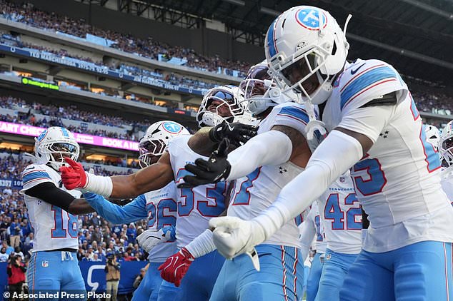 Tennessee Titans safety Amani Hooker, second from right, celebrates his interception with teammates during the first half of an NFL football game against the Indianapolis Colts, Sunday, Oct. 18, 2026, in Indianapolis. (AP Photo/Jeff Roberson)