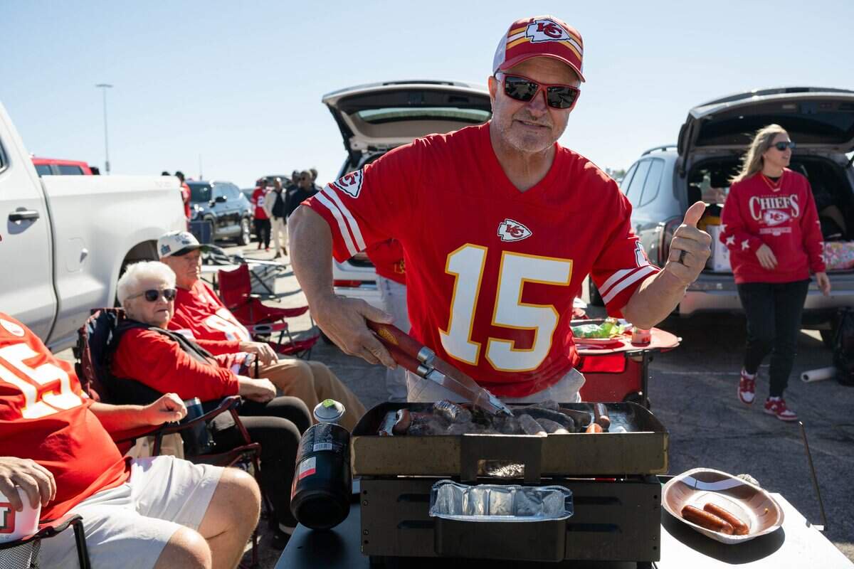 Jeff Wingfield cooks meat at his tailgate outside the stadium prior to the Chiefs game vs. the Los Angeles Chargers, on Sunday, October 18, 2026, at Arrowhead Stadium. Wingfield traveled with his family from North Carolina for the game.