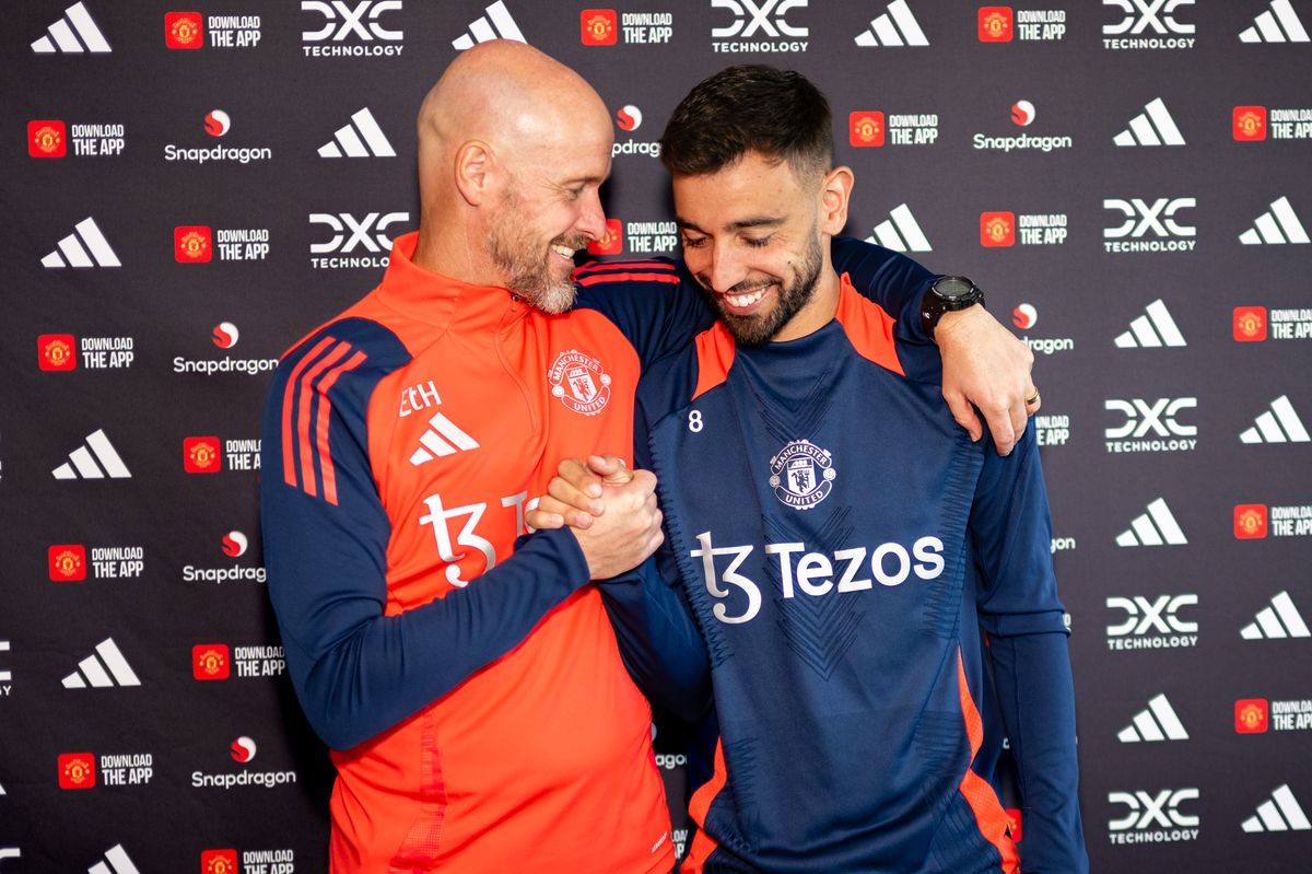 Bruno Fernandes of Manchester United poses with Manager Erik ten Hag after signing.a contract extension with the club at Carrington Training Ground