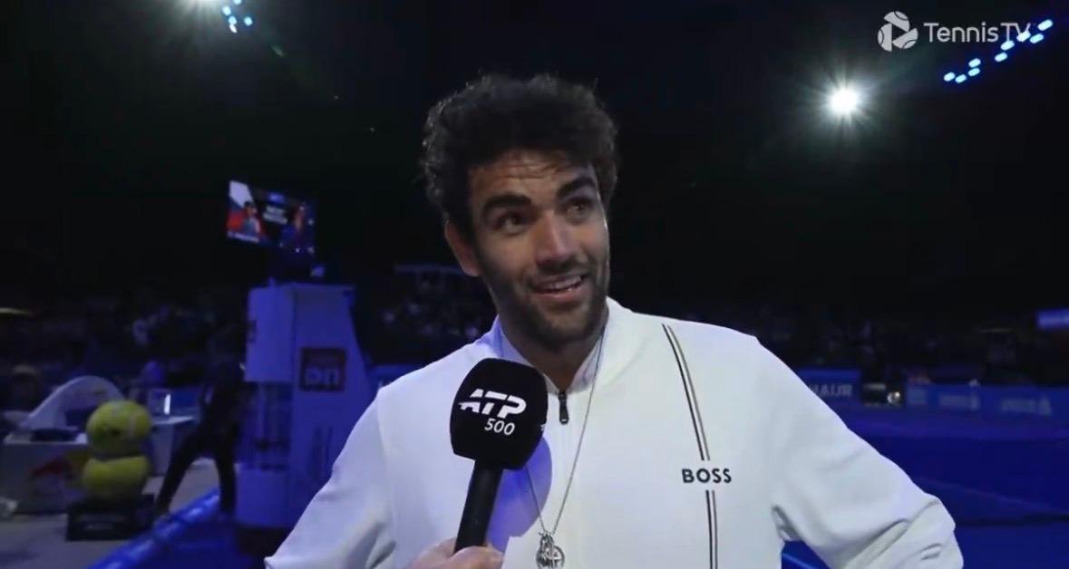 Matteo Berrettini awkwardly smiles when asked about Lorenzo Musetti during an interview. 