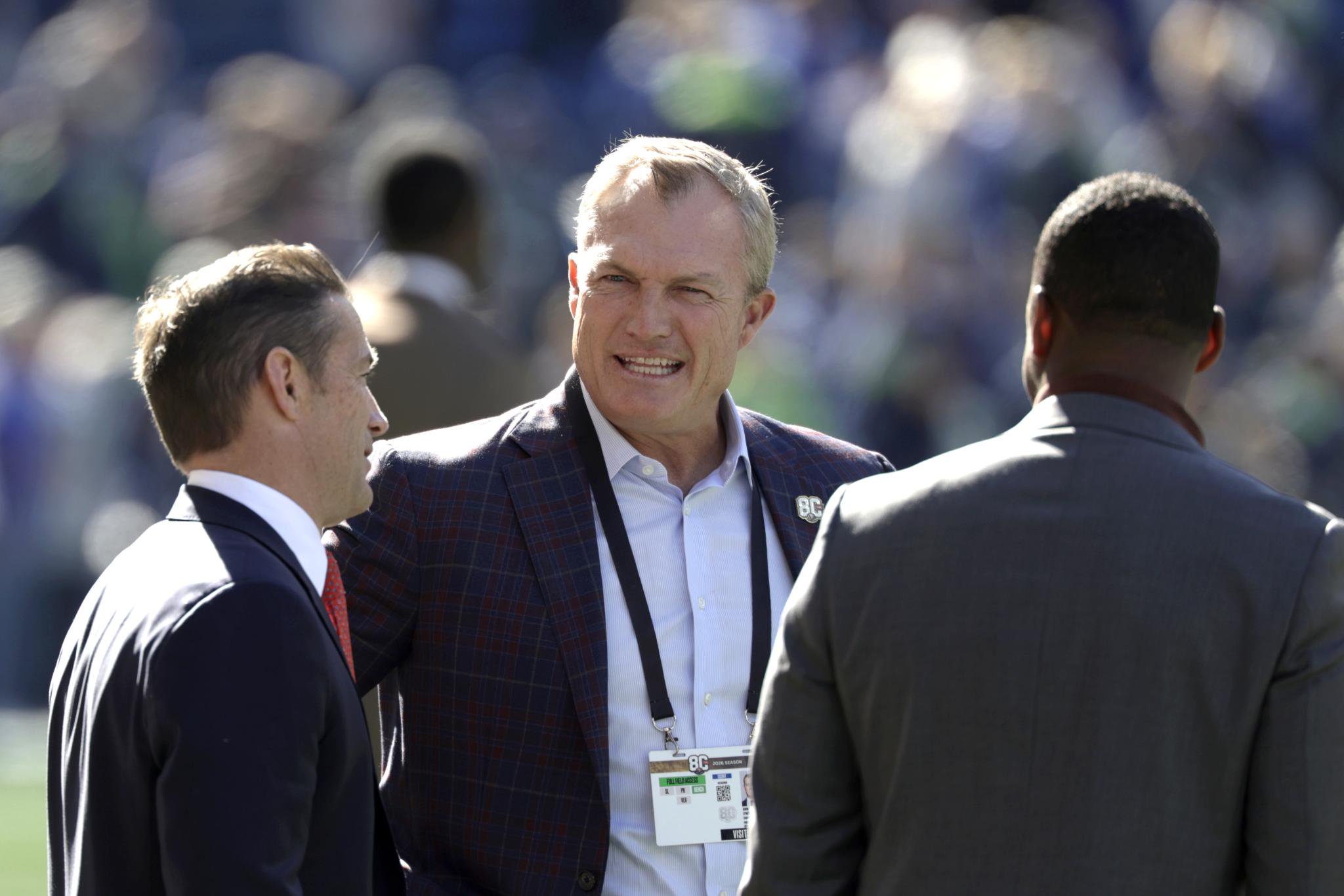 San Francisco 49ers general manager John Lynch chats on the field before a game against the Seattle Seahawks at Lumen Field in Seattle, Washington, Sunday, Oct. 11, 2026.