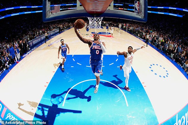 Philadelphia 76ers' Tyrese Maxey (0) goes up for a shot past Cleveland Cavaliers' Donovan Mitchell (45) during the second half of an NBA basketball game Thursday, Oct. 22, 2026, in Philadelphia. (AP Photo/Matt Slocum)