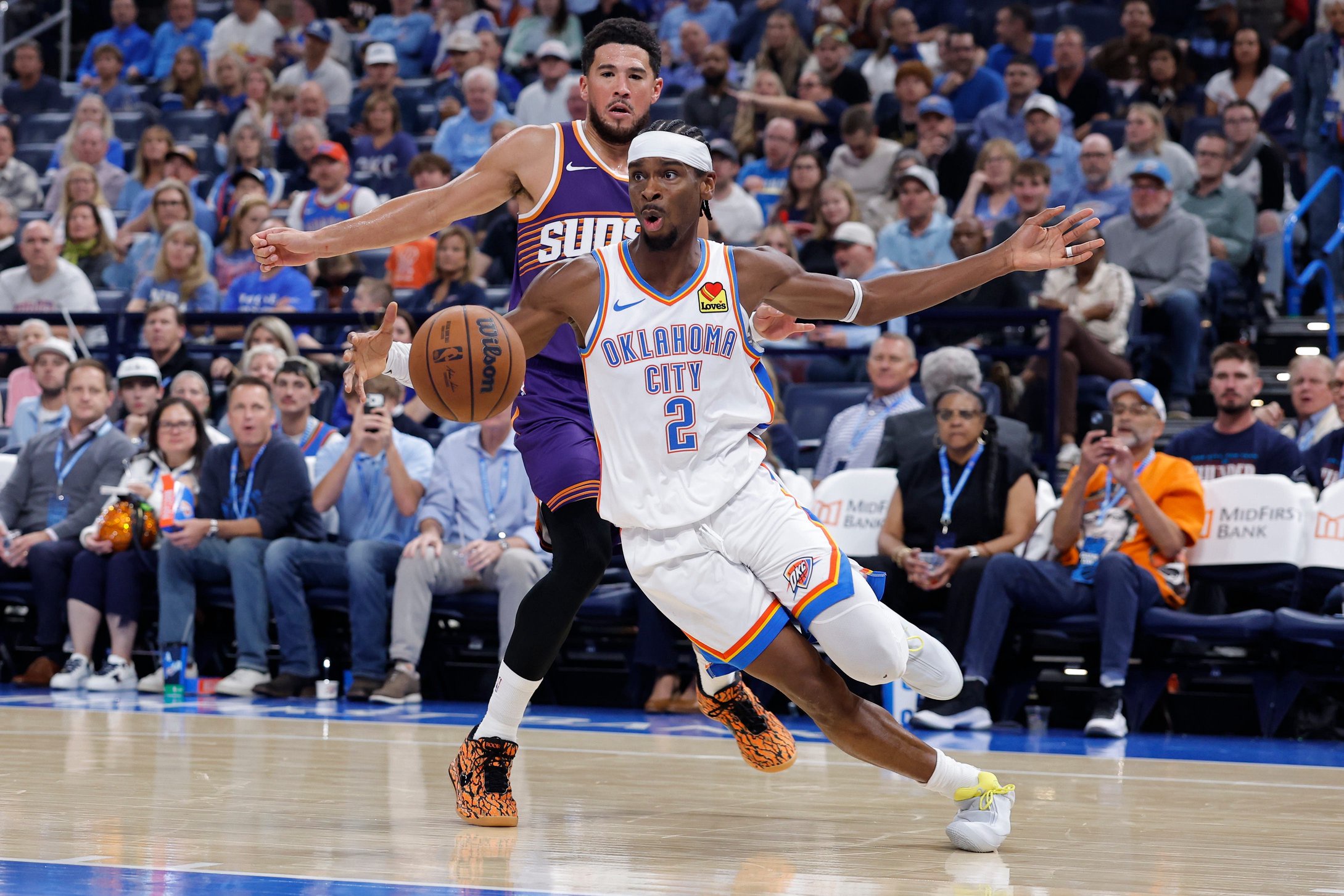 Oct 26, 2026; Oklahoma City, Oklahoma, USA; Oklahoma City Thunder guard Shai Gilgeous-Alexander (2) moves the ball around Phoenix Suns guard Devin Booker (15) during the second half at Paycom Center. Mandatory Credit: Alonzo Adams-Imagn Images