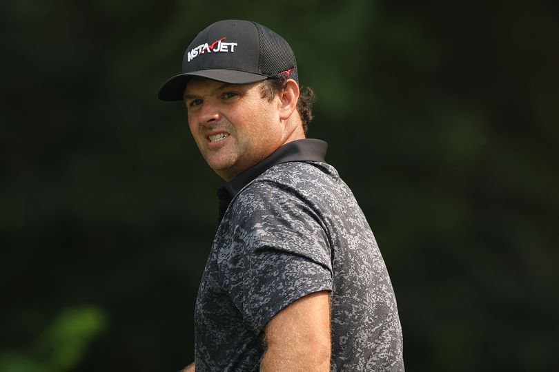 Patrick Reed looks on