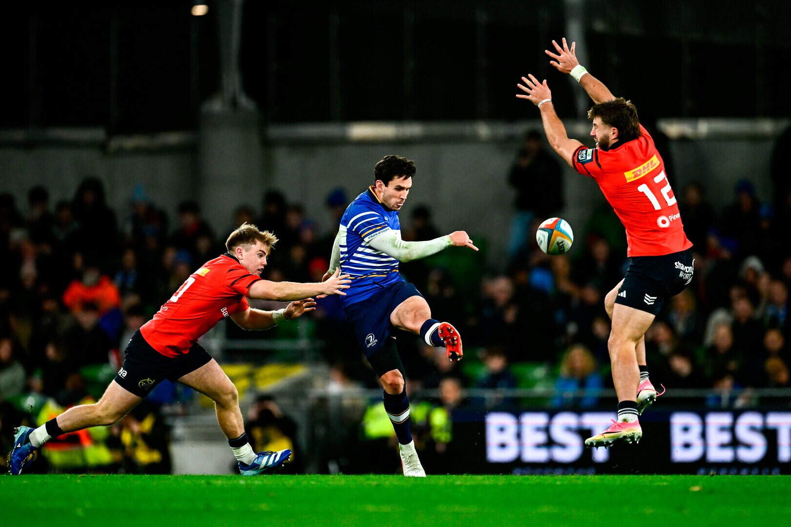 Leinster’s Joey Carbery in action against Charlie O'Shea, left, and Alex Nankivell of Munster during the URC match at the Aviva Stadium in Dublin