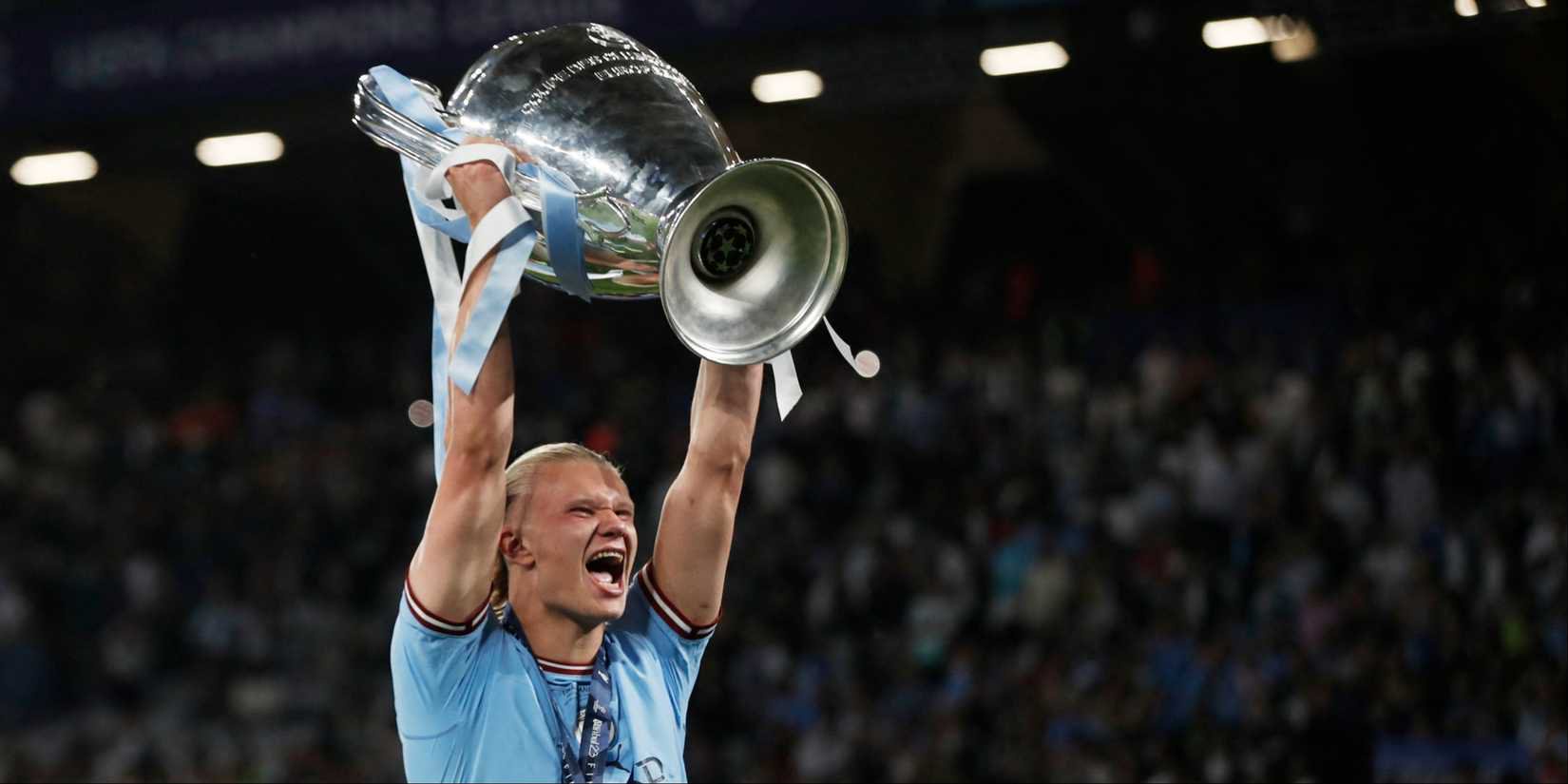 Manchester City's Erling Haaland lifts the Champions League trophy. 
