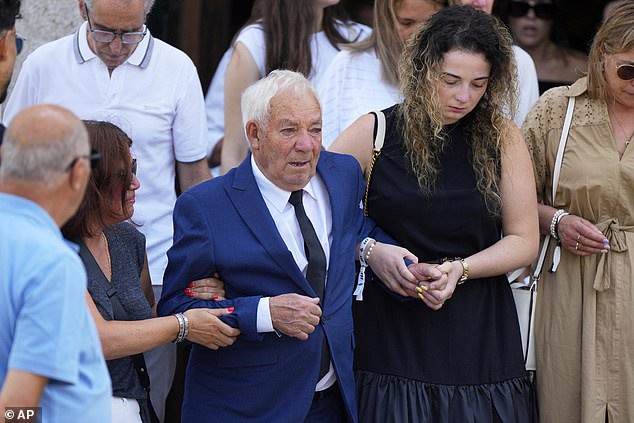 Joaquim Silva, grandfather of Jota and Silva was supported by family members as he made his way tot he church following behind his grandsons's coffins