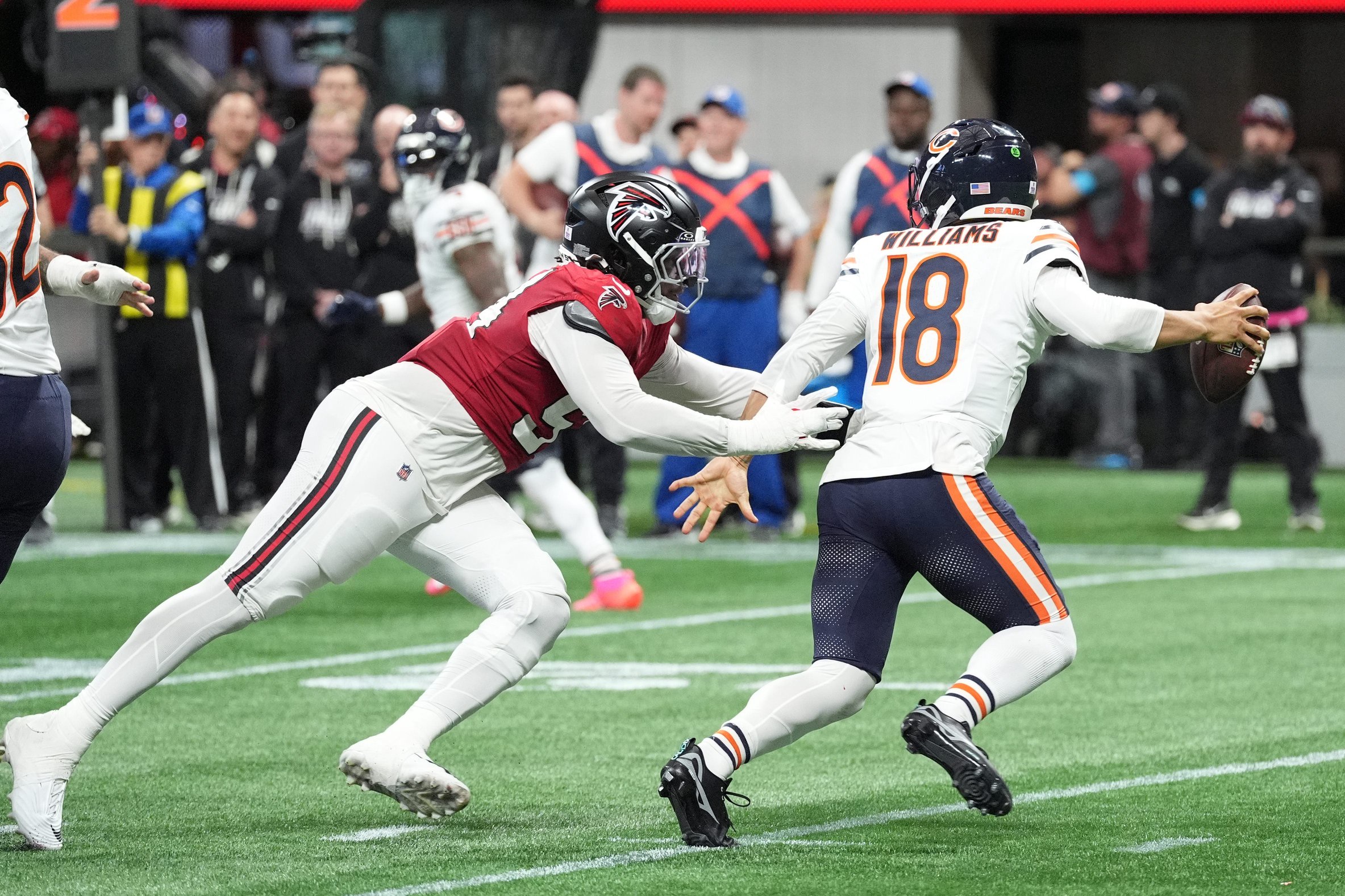 Oct 18, 2026; Atlanta, Georgia, USA;  Atlanta Falcons defensive line Brandon Dorlus (54) chases Chicago Bears quarterback Caleb Williams (18) during the second quarter at Mercedes-Benz Stadium.  Mandatory Credit: Dale Zanine-Imagn Images