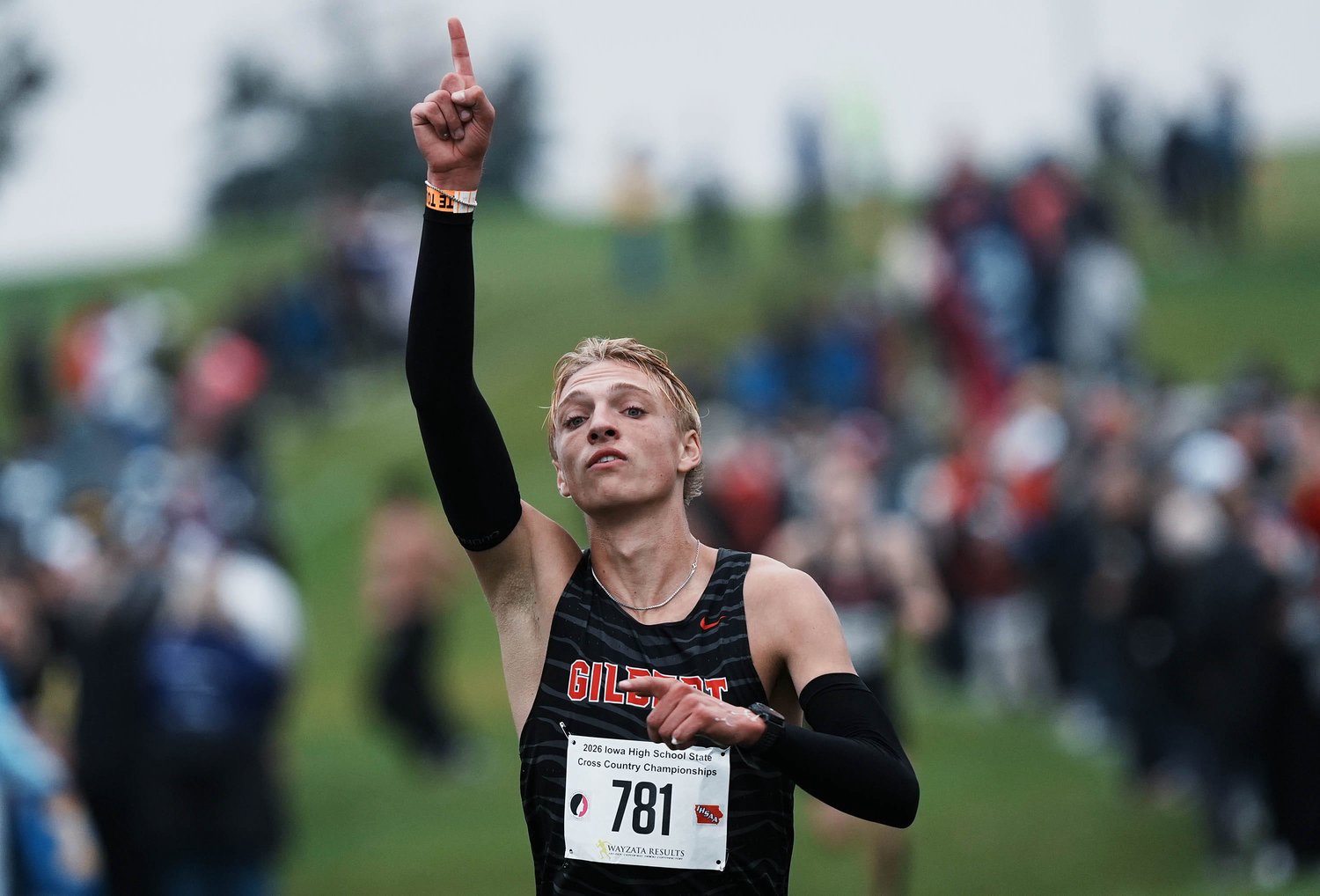 Gilbert’s Logan Bleich celebrates as crossing the finishing line after winning the Class 3A boys state cross country race at Lakeside Municipal Golf Course on Oct. 31, 2026, in Fort Dodge, Iowa.