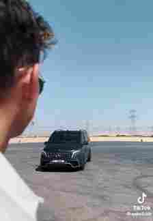 The footage shows the club founder awaiting a black van driving towards them in the desert