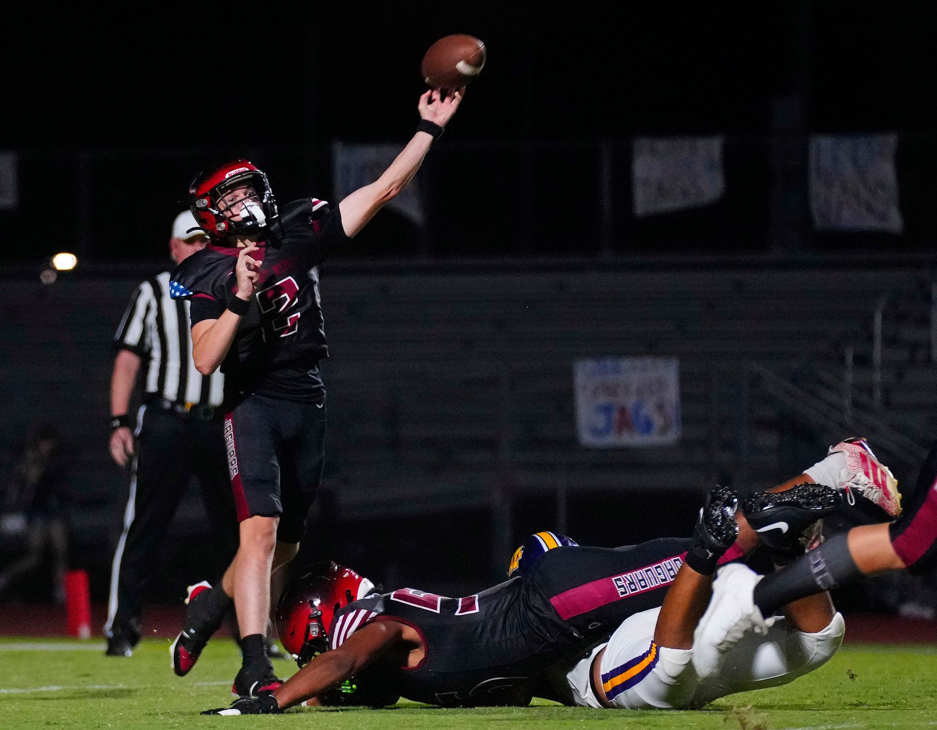 Desert Ridge quarterback Gunner Brewer (2) throws a pass under pressure from Mesa during a game at Desert Ridge High School in Mesa, on Sept. 18, 2025.