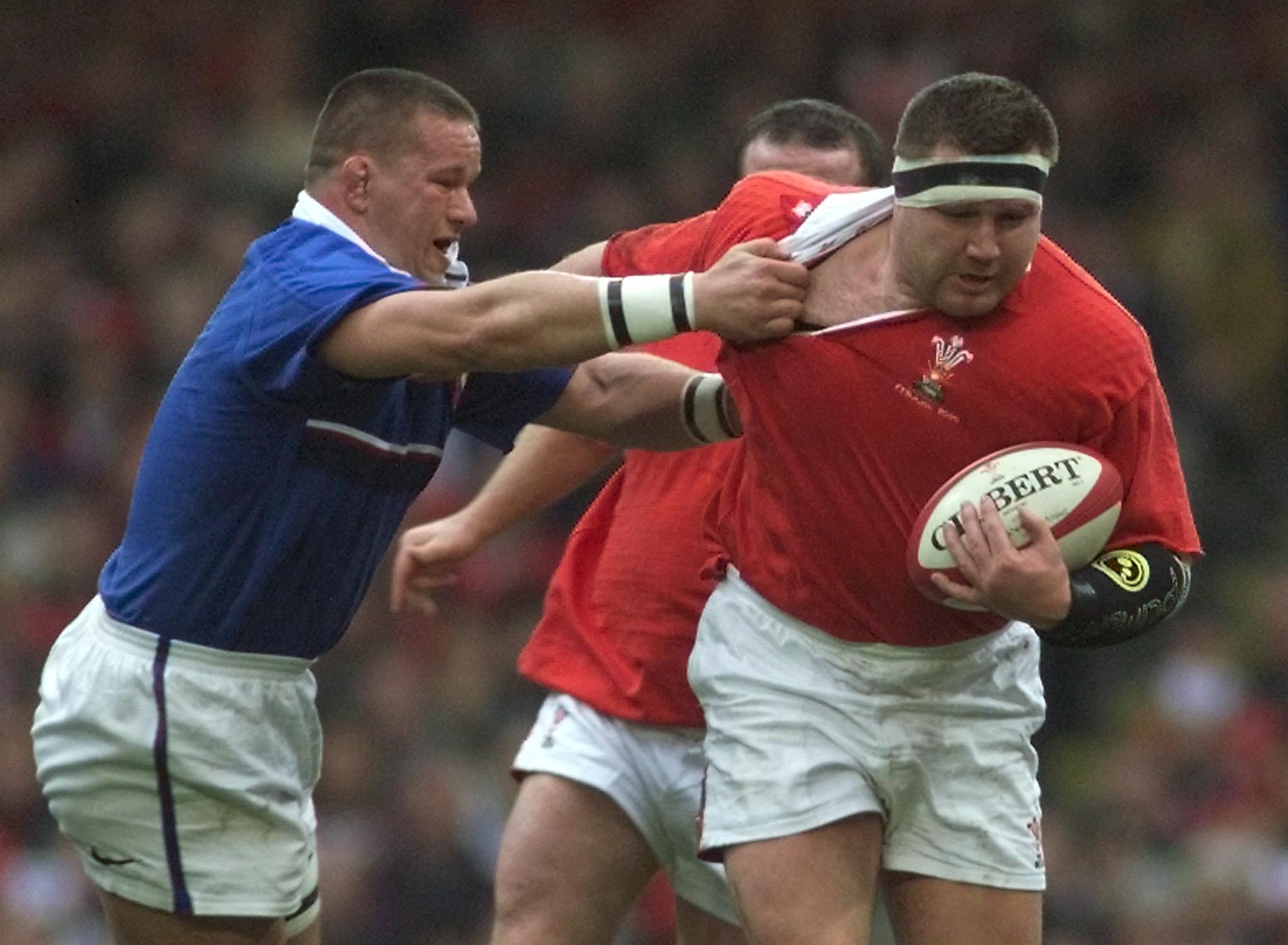 Wales Dai Young charges through a tackle from France's Christian Califano during the 2000 Six Nations match