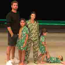 Scott Disick and kourtney Kardashian posing with their three kids