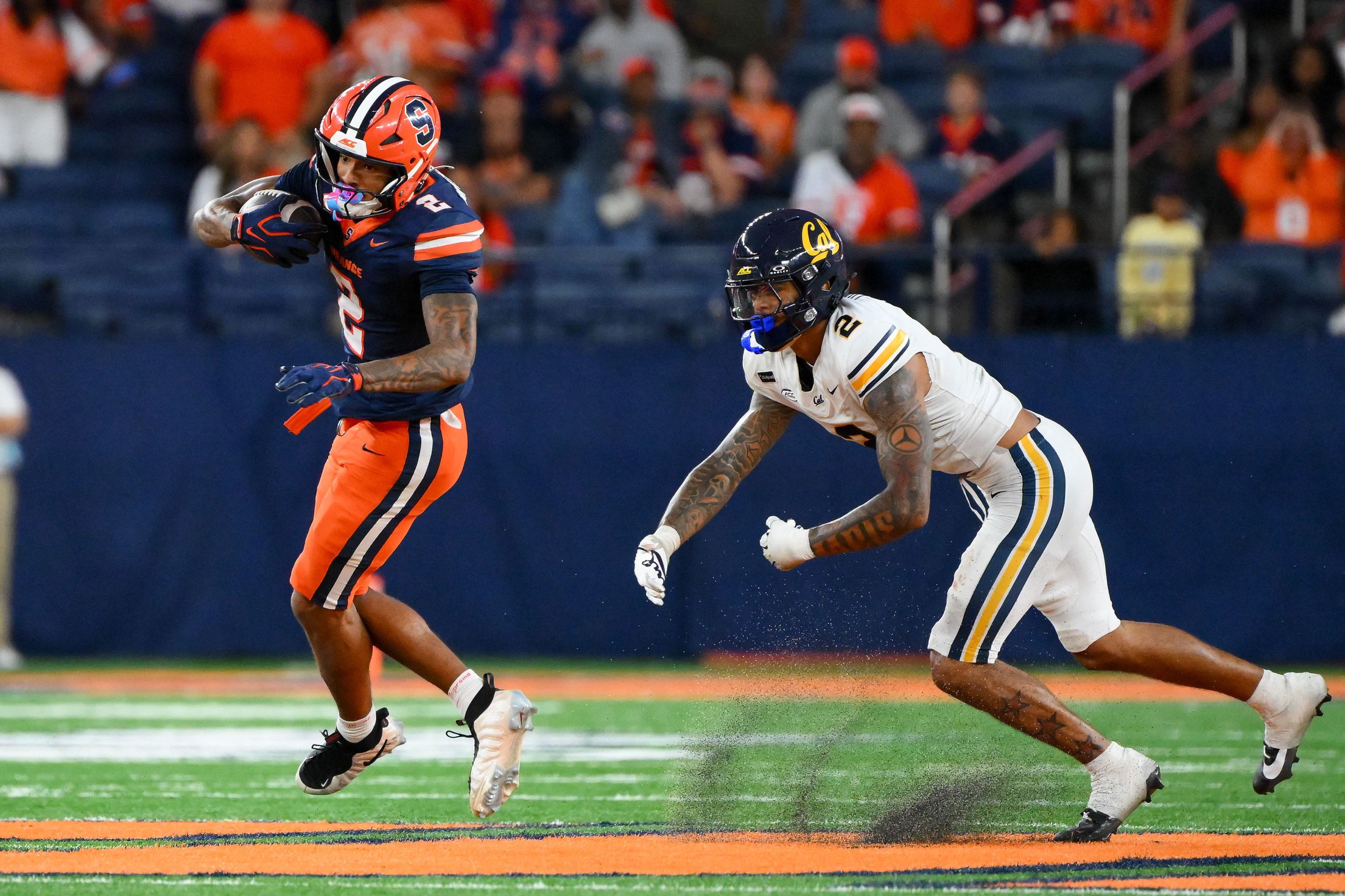 Sep 12, 2026; Syracuse, New York, USA; Syracuse Orange wide receiver Umari Hatcher (2) avoids the tackle attempt of California Golden Bears defensive back Kingston Lopa (2) during the second half at the JMA Wireless Dome. Mandatory Credit: Rich Barnes-Imagn Images
