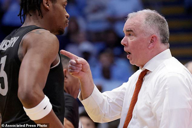 FILE - Virginia Tech head coach Mike Young, right, instructs forward Amani Hansberry, left, during the second half of an NCAA college basketball game against North Carolina, Saturday, Feb. 28, 2026, in Chapel Hill, N.C. (AP Photo/Chris Seward,File)